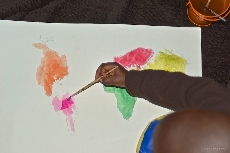 A 4 year old learning the continents through an activity - drawing and painting