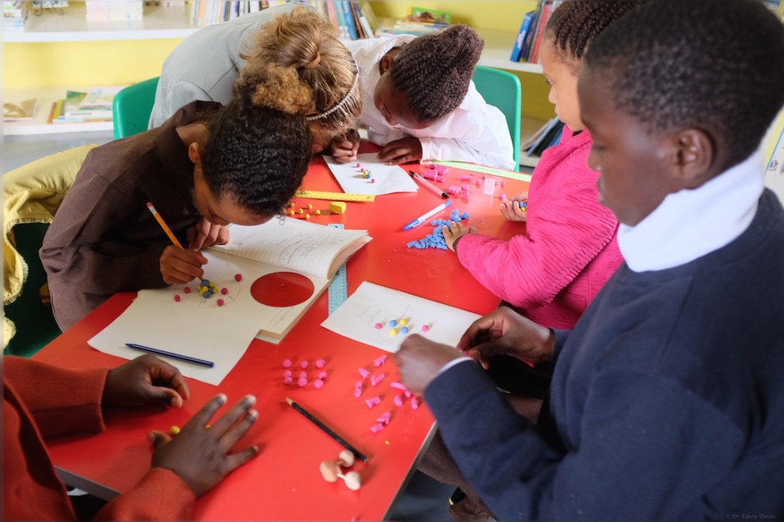 Our young scientists carefully building new atoms